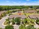 Beautiful aerial view of the condo complex surrounded by mature trees and lush landscaping at 2943 Willowleaf Ln, Wesley Chapel, FL 33544