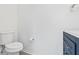This half bath features a blue vanity with a white countertop and a decorative towel rack at 2943 Willowleaf Ln, Wesley Chapel, FL 33544