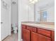 This bathroom features a vanity, toilet, and a mirror at 2943 Willowleaf Ln, Wesley Chapel, FL 33544