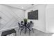 Cozy dining area with a round table, four chairs, and unique wall art at 2943 Willowleaf Ln, Wesley Chapel, FL 33544