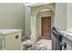 Close-up of the private courtyard entry featuring brick pavers and a black metal gate at 2943 Willowleaf Ln, Wesley Chapel, FL 33544