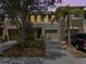 Charming two-story townhome with a well-maintained lawn, mature trees, and a private driveway at 2943 Willowleaf Ln, Wesley Chapel, FL 33544