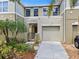 Attractive townhouse featuring a private courtyard with gate, and a one car garage at 2943 Willowleaf Ln, Wesley Chapel, FL 33544