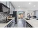 Modern kitchen with gray cabinets and stainless steel appliances at 2943 Willowleaf Ln, Wesley Chapel, FL 33544