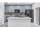 Modern kitchen with gray cabinets, stainless steel appliances, and mosaic backsplash at 2943 Willowleaf Ln, Wesley Chapel, FL 33544