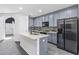Bright kitchen with grey cabinets and stainless steel appliances at 2943 Willowleaf Ln, Wesley Chapel, FL 33544