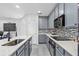 Bright kitchen with grey cabinets, quartz countertops and modern appliances at 2943 Willowleaf Ln, Wesley Chapel, FL 33544