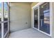 Private lanai with sliding glass doors and a view, seamlessly blending indoor comfort with outdoor serenity at 2943 Willowleaf Ln, Wesley Chapel, FL 33544