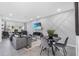 Open concept living room featuring stylish decor, modern furnishings, and sleek finishes at 2943 Willowleaf Ln, Wesley Chapel, FL 33544