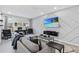 Comfortable living room featuring gray tones, modern furniture, and a decorative accent wall at 2943 Willowleaf Ln, Wesley Chapel, FL 33544