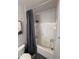 Bathroom with a shower/tub combo, gray shower curtain, gray rug, white tile, and toilet at 4333 Bayside Village Dr # 310, Tampa, FL 33615