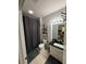 Bathroom with a gray shower curtain, tile floors, black countertop, and built in storage shelves at 4333 Bayside Village Dr # 310, Tampa, FL 33615