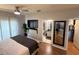 Comfortable bedroom has ceiling fan, hardwood floors, a plant, and access to the bathroom and closet at 4333 Bayside Village Dr # 310, Tampa, FL 33615