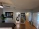 Bedroom view with ceiling fan, hardwood floors, a plant, bathroom, walk-in closet, and TV at 4333 Bayside Village Dr # 310, Tampa, FL 33615