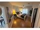 Cozy bedroom with hardwood floors, ceiling fan, painting, and natural light from the windows at 4333 Bayside Village Dr # 310, Tampa, FL 33615