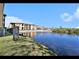 Scenic community view featuring a pond, fountain, and well-maintained buildings against a blue sky at 4333 Bayside Village Dr # 310, Tampa, FL 33615