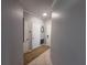 Inviting hallway featuring tile flooring, neutral walls, white doors, and elegant trim work at 4333 Bayside Village Dr # 310, Tampa, FL 33615