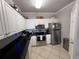 Modern kitchen with stainless steel appliances, black countertops, and white cabinetry at 4333 Bayside Village Dr # 310, Tampa, FL 33615