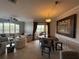 Open living and dining area with tile flooring, comfortable seating, and access to a balcony at 4333 Bayside Village Dr # 310, Tampa, FL 33615
