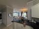 A stylish kitchen overlooking the open-concept living and dining spaces at 4333 Bayside Village Dr # 310, Tampa, FL 33615