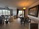 Open living and dining area with tile flooring, comfortable seating, and access to a balcony at 4333 Bayside Village Dr # 310, Tampa, FL 33615