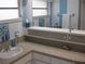 Bathroom featuring granite countertop, white fixtures, and neutral decor at 7026 Lenape Cir, New Port Richey, FL 34653