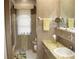 Well-lit bathroom featuring a vanity, sink, and shower with a window at 7026 Lenape Cir, New Port Richey, FL 34653