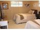 Cozy bedroom featuring twin beds, natural light from a window, and charming decor at 7026 Lenape Cir, New Port Richey, FL 34653