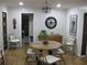 Elegant dining room with modern chandelier, round table, and four stylish chairs at 7026 Lenape Cir, New Port Richey, FL 34653