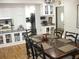 Dining area with a dark wooden table and chairs adjacent to the kitchen and breakfast bar at 7026 Lenape Cir, New Port Richey, FL 34653