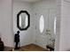 Foyer with an ornate mirror and a double door with stained glass, and a decorative statue at 7026 Lenape Cir, New Port Richey, FL 34653