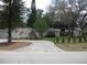 Charming single-story home with a well-manicured lawn and mature trees, including a circular driveway at 7026 Lenape Cir, New Port Richey, FL 34653