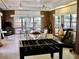 Spacious game room featuring a foosball table, ping pong table, and multiple seating areas at 7026 Lenape Cir, New Port Richey, FL 34653