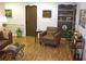 Comfortable living room featuring wood-look flooring, a cozy armchair, and tasteful decor, creating a relaxing space at 7026 Lenape Cir, New Port Richey, FL 34653