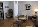 Comfortable living room area with a decorative world map, white chair and views of the hallway at 7026 Lenape Cir, New Port Richey, FL 34653