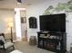 Open-concept living room featuring a TV and fireplace, cozy seating area, and ample natural light at 7026 Lenape Cir, New Port Richey, FL 34653