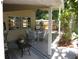 Covered patio featuring a dining table with chairs and a ceiling fan, with outdoor greenery at 7026 Lenape Cir, New Port Richey, FL 34653