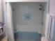 Step-in shower features blue tiling, a built-in shower bench, and dual shower heads at 7026 Lenape Cir, New Port Richey, FL 34653