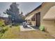 Private backyard patio area with comfortable seating, awnings, and lush greenery, perfect for outdoor relaxation at 7418 Riverbank Dr, New Port Richey, FL 34655