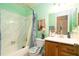 Fresh bathroom with marble-patterned shower and wooden vanity at 7418 Riverbank Dr, New Port Richey, FL 34655