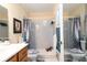Bright bathroom with white tile and dark wood vanity at 7418 Riverbank Dr, New Port Richey, FL 34655