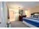 Well-lit bedroom with carpeted floors and blue striped bedding at 7418 Riverbank Dr, New Port Richey, FL 34655