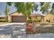 A cozy single-Gathering home featuring a well-manicured front lawn, decorative shrubbery and a convenient two-car garage at 7418 Riverbank Dr, New Port Richey, FL 34655