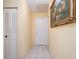 Bright hallway with tile flooring and white doors at 7418 Riverbank Dr, New Port Richey, FL 34655