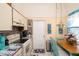 Bright kitchen features stone countertops, white appliances, and a cozy breakfast nook for casual dining at 7418 Riverbank Dr, New Port Richey, FL 34655