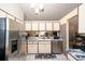 Efficient kitchen with stainless steel appliances, white cabinetry, and durable countertops for easy meal preparation at 7418 Riverbank Dr, New Port Richey, FL 34655