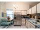 Open kitchen with stainless steel appliances, a dining area, and ample cabinet space for storage and meal preparation at 7418 Riverbank Dr, New Port Richey, FL 34655