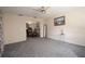 Cozy living room with ceiling fan, painting, and view into the dining area with mirrored wall feature at 7418 Riverbank Dr, New Port Richey, FL 34655
