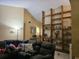 A cozy living room with comfortable seating, tall ceilings, and a custom-built bookcase for displaying decorative items at 7418 Riverbank Dr, New Port Richey, FL 34655