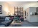 Inviting living room featuring a large, comfortable sectional sofa and a stylish decorative display shelf at 7418 Riverbank Dr, New Port Richey, FL 34655